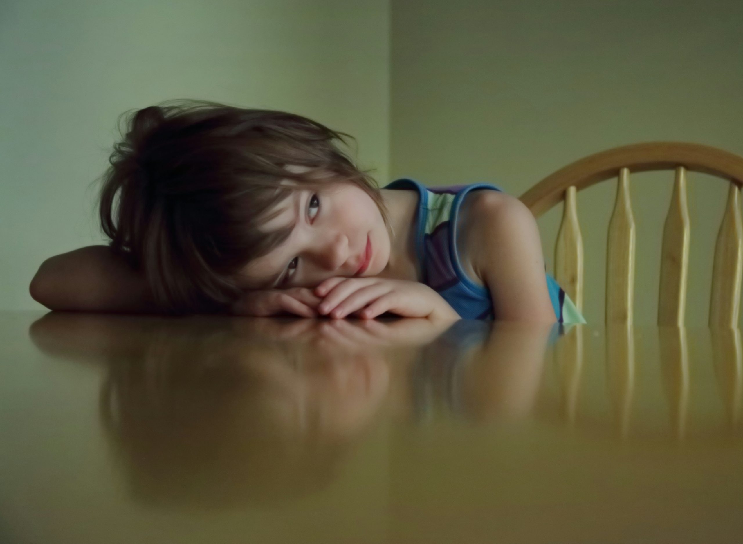Young girl resting her head on a table