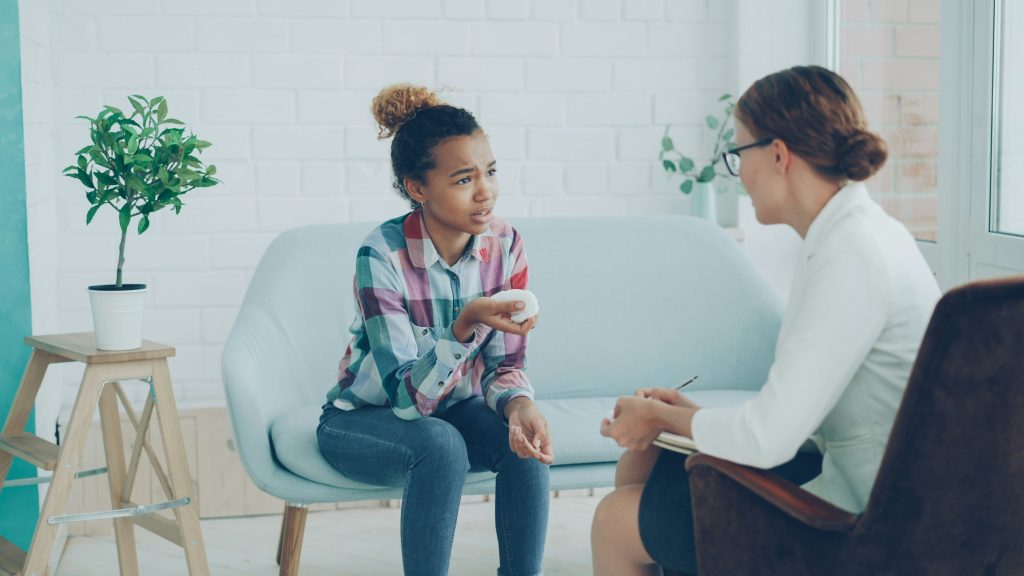 Female teenager talking to a female homeopath.